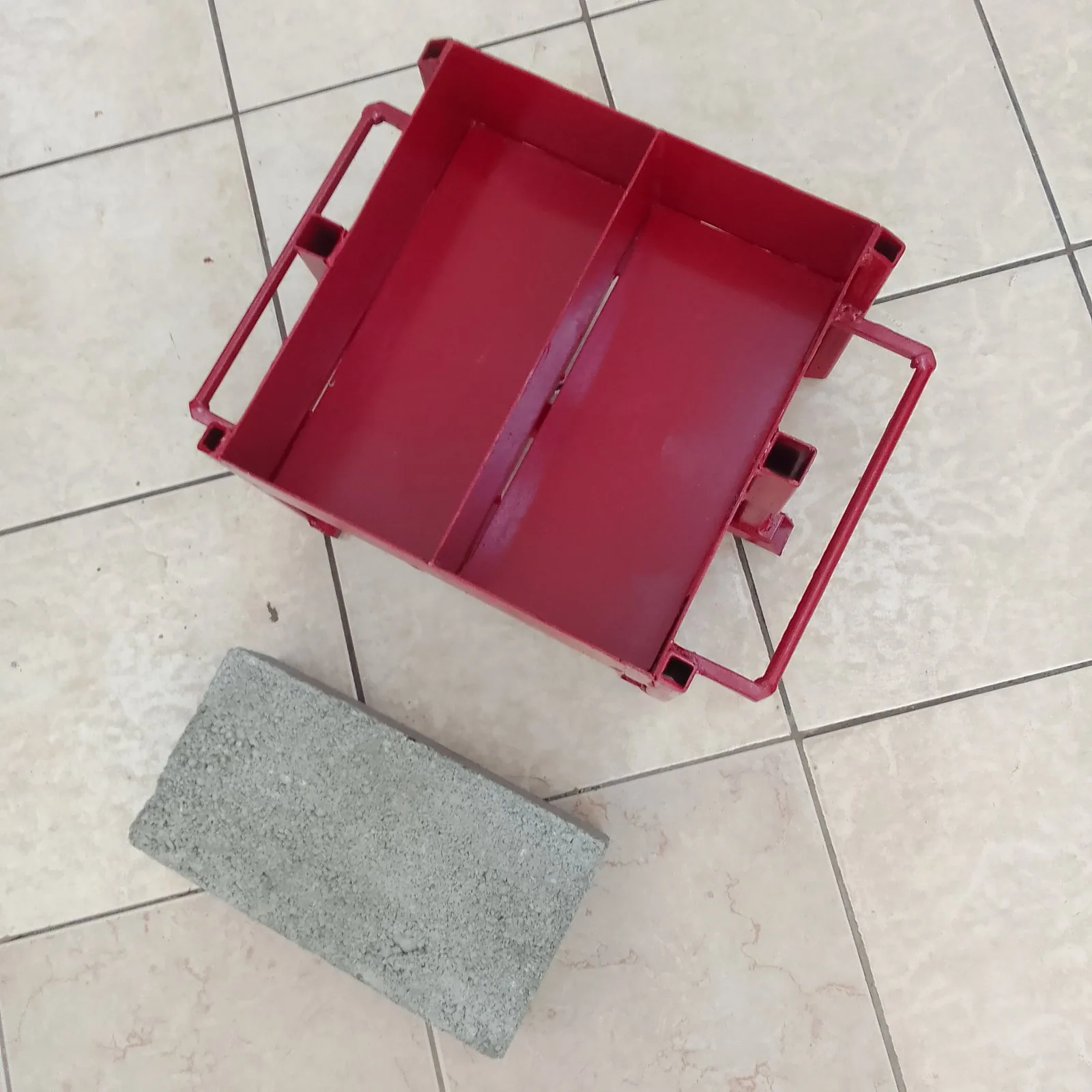 Hand-Pressed Maxi Brick Mould, 2 Bricks per Press Hand-pressed steel maxi brick mould with two cavities beside a finished maxi brick