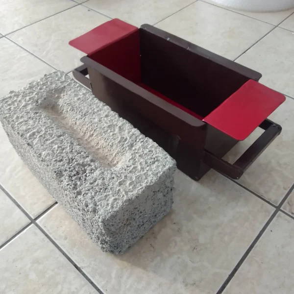 Hand-pressed steel V block mould with a finished V block on tiles