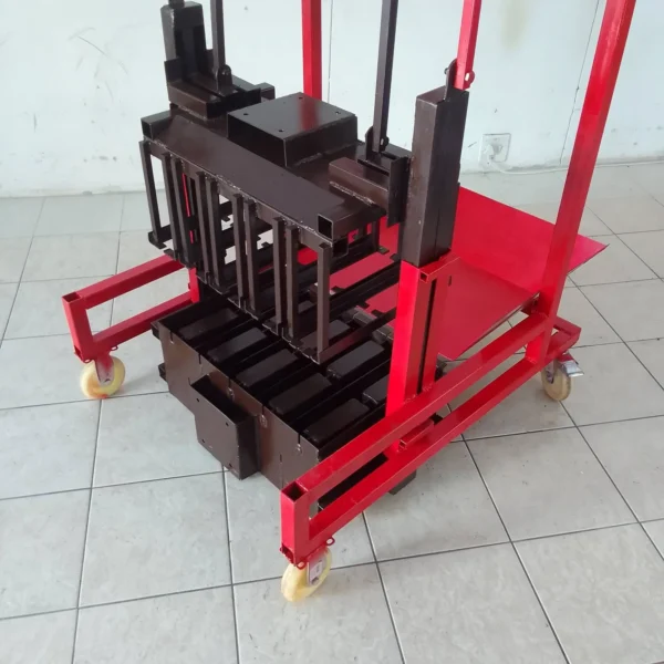 Manual egg-layer brick making machine with pre-installed mould displayed in a showroom