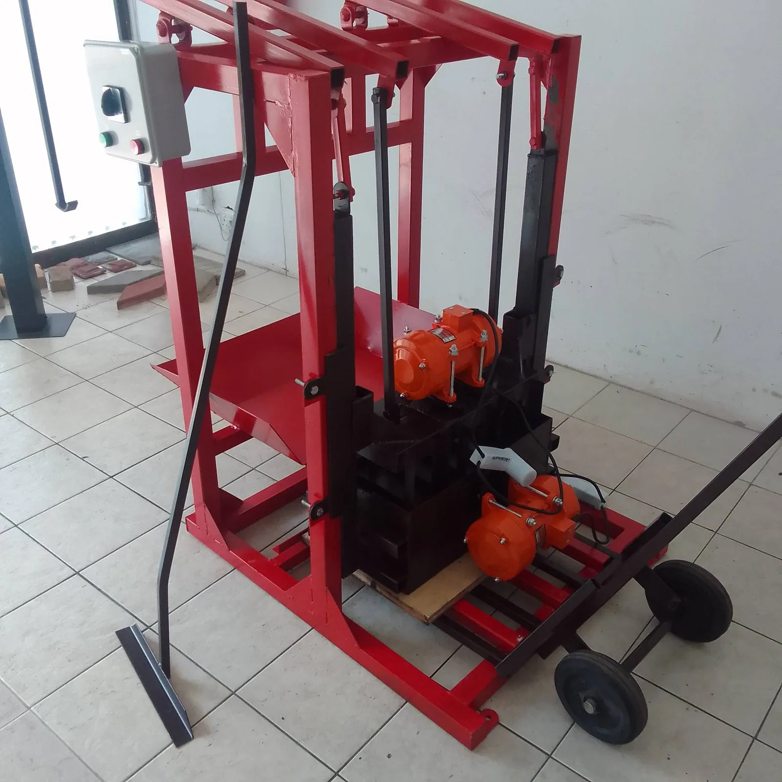 Power Electric Static Brick Machine, Twin Vibrator Motors Power electric static brick machine with twin vibrator motors and pre-installed mould in a showroom